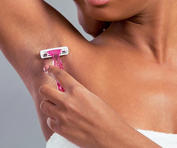 woman shaving armpits