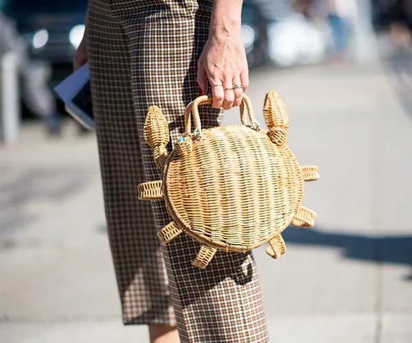Trendy straw bag featuring vibrant summer designs.