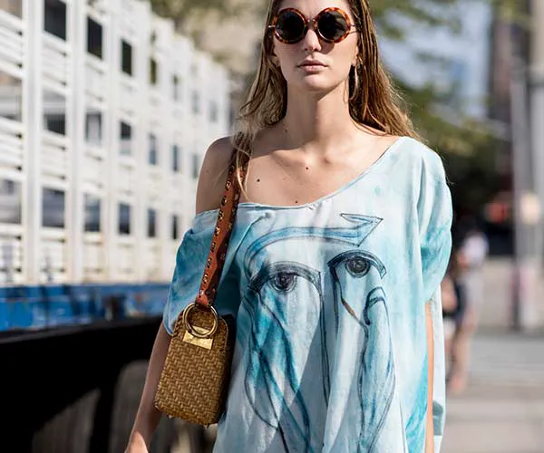 Fashionable straw bag with playful summer accents.