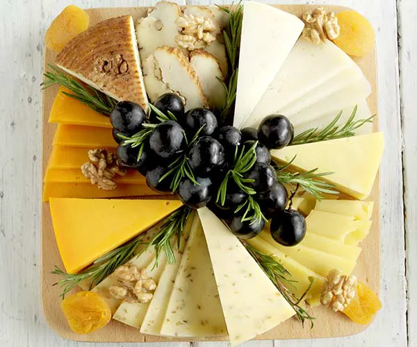 Elegant wine and gourmet food pairing on a rustic table.