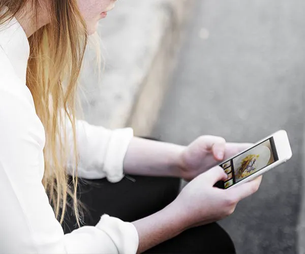 Consider The Size Of Your Hands Hands holding an iPhone, capturing a celebrity podcast moment.