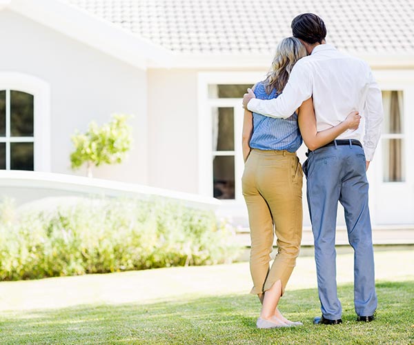 couple in front of new house