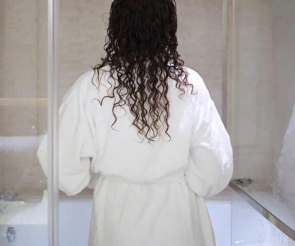 Relaxed woman with a nighttime hair care routine.