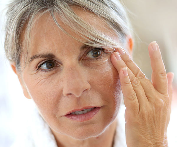 woman applying concealer