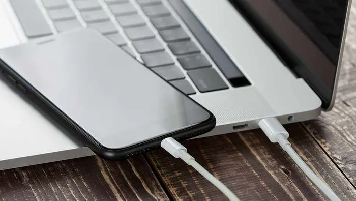 "Charging iPhone using a laptop"