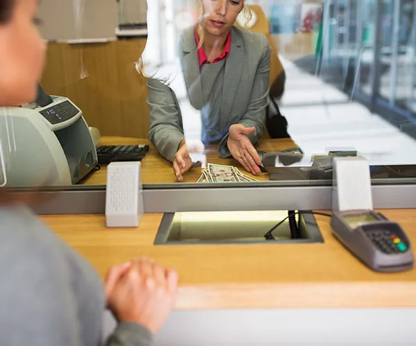 How To Update Your Bank Account and Credit Card woman at bank