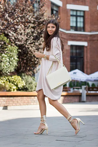 Mysterious girl in a chic outfit against a vibrant backdrop.