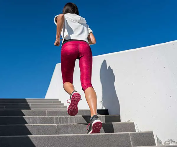 woman running up stairs