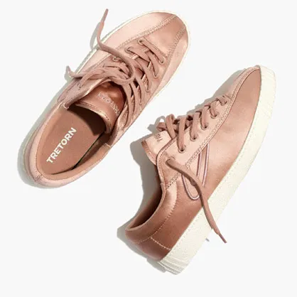 Madewell Tretorn sneakers in a stylish urban setting.