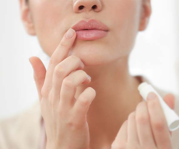 woman applying chapstick