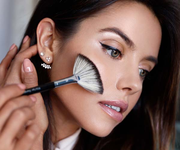 woman applying highlighter