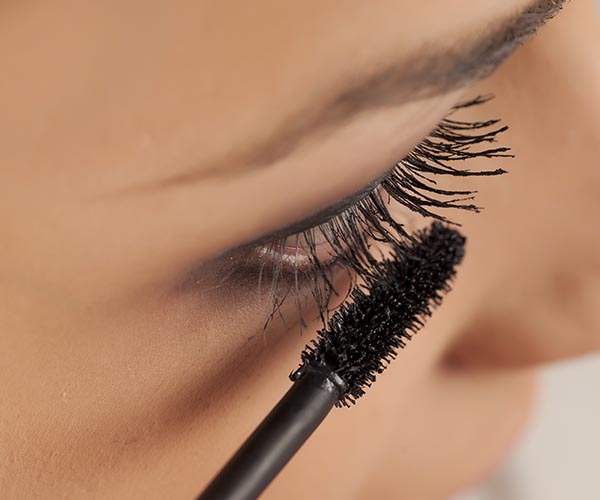 woman applying mascara