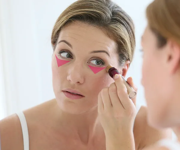 woman applying concealer