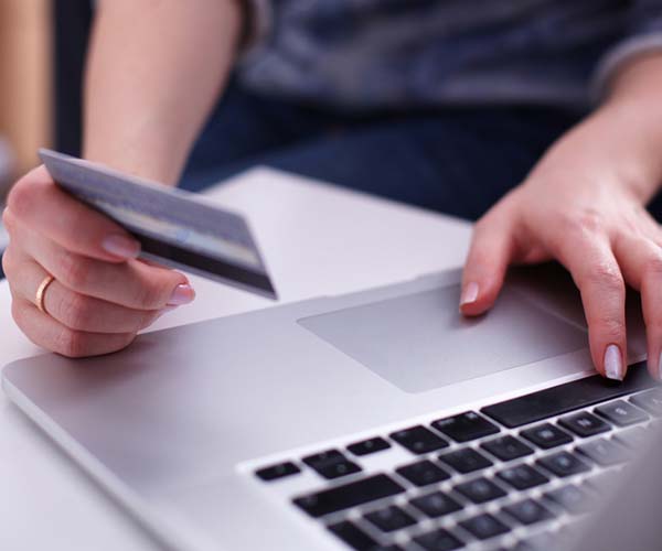 woman reading credit number online shopping