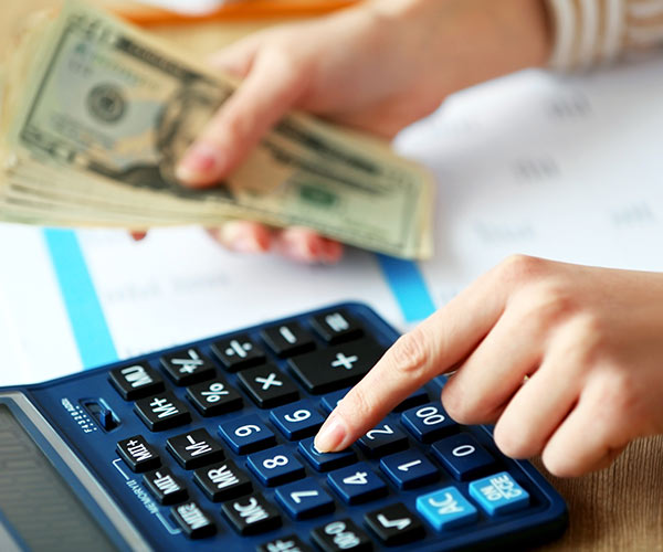 woman budgeting using a calculator