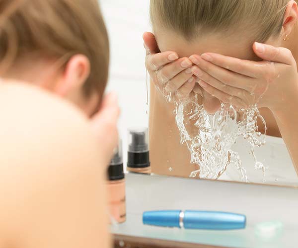 woman washing face in skin
