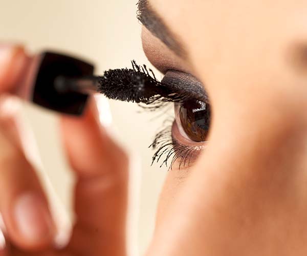 woman applying mascara