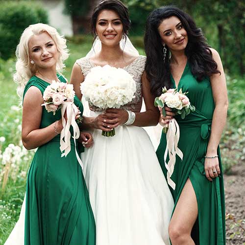 Dressing Your Maids In Dark Colors bride posing with bridesmaids outside