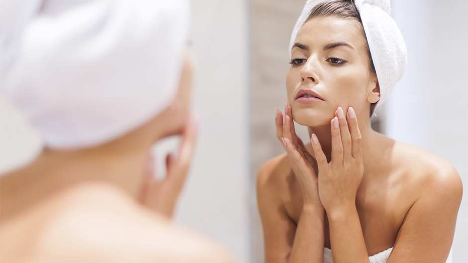 woman looking in mirror