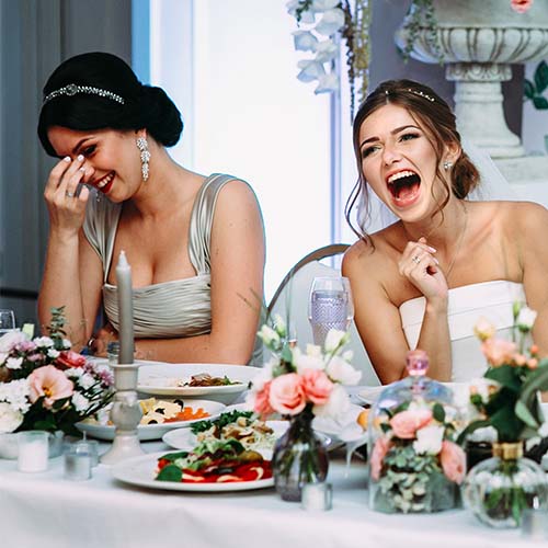 Bride and bridesmaid laughing