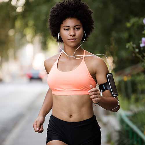 woman running listening to headphones