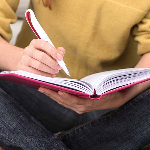 woman writing in journal