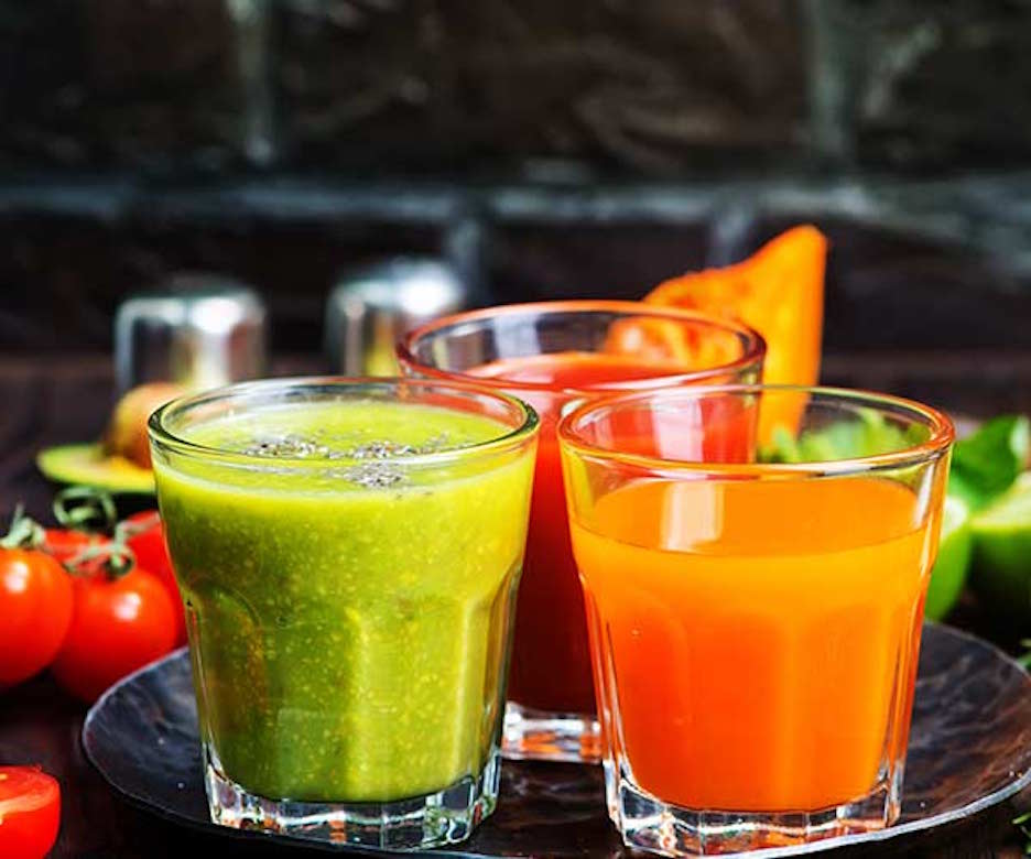 assorted colorful juices in glasses
