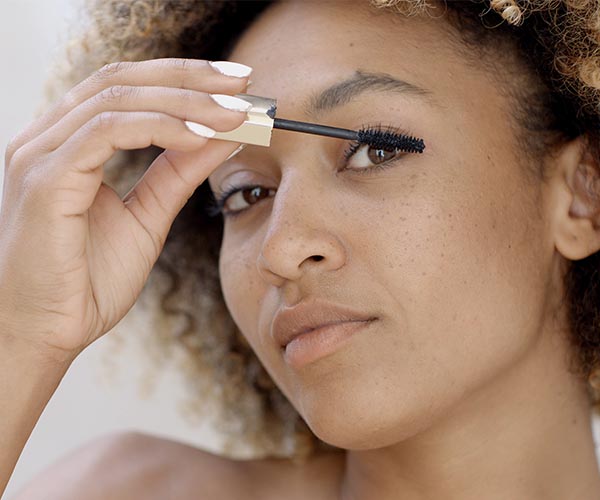 woman applying mascara