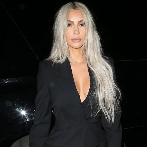 Kim Kardashian posing confidently in a chic outfit.