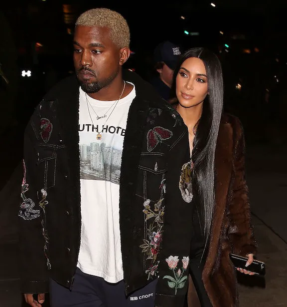 Kim Kardashian and Kanye West sharing a moment on the red carpet.