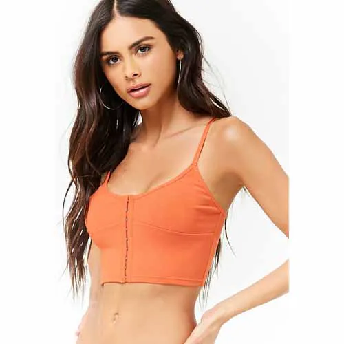 "Hailey Baldwin wearing a bright orange crop top"