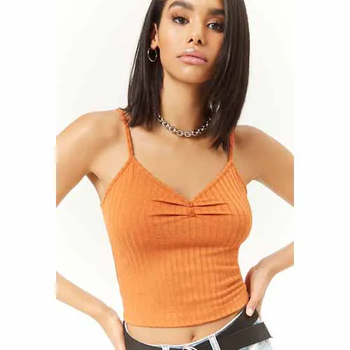 "Hailey Baldwin in a stylish outdoor setting wearing a crop top"