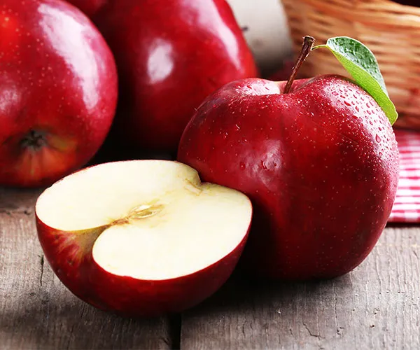 Fresh red apple on a wooden table