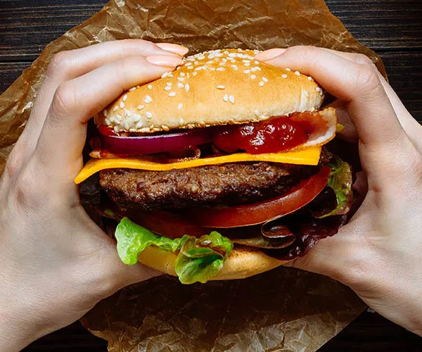 Deliciously stacked burger with crispy bacon and vegetables