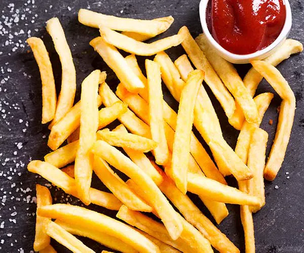 Crispy golden French fries served in a rustic bowl