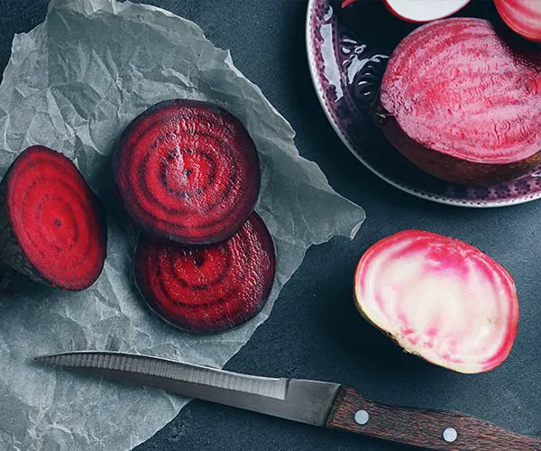 Fresh beets on a wooden table for healthy eating.