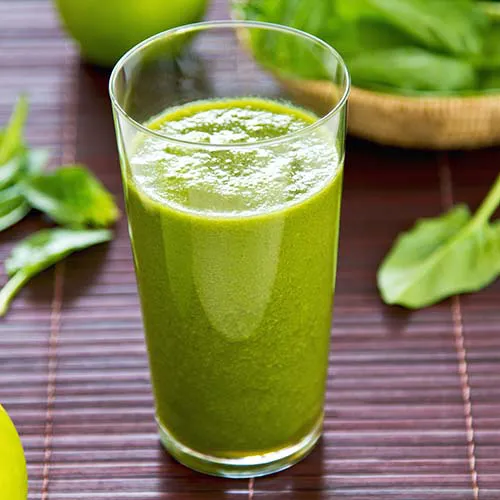 Freshly made green juice in a glass.