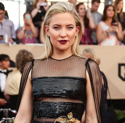 Kate Hudson smiling in a chic casual look.
