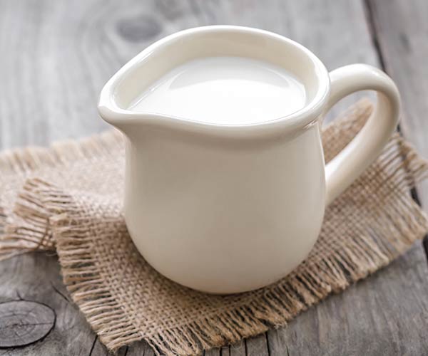 small white saucer filled with milk