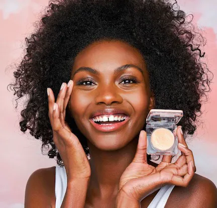 woman holding the kopari starry eye balm