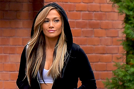 Jennifer Lopez in a black, velour hoodie.