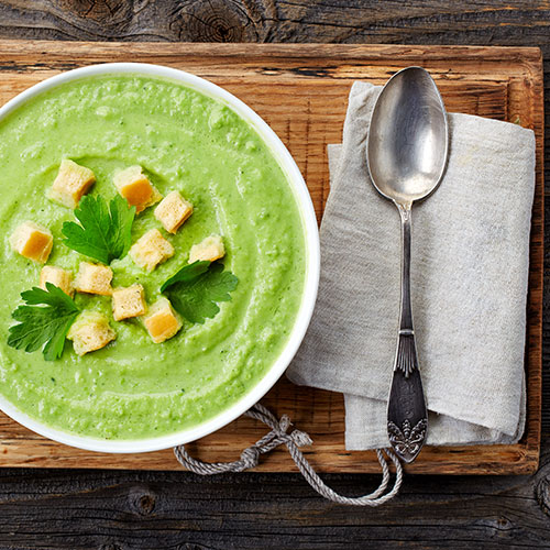 Red pepper and avocado soup in a bowl.