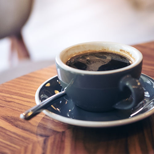 A cup of coffee in a blue mug.