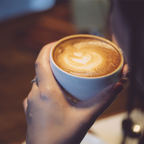 A person holding a latte.