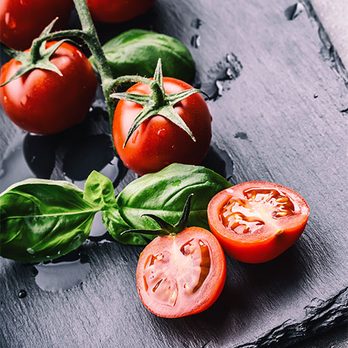 Fresh tomatoes on a wood surface.