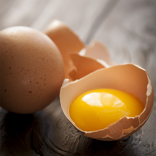 A cracked egg on a table.