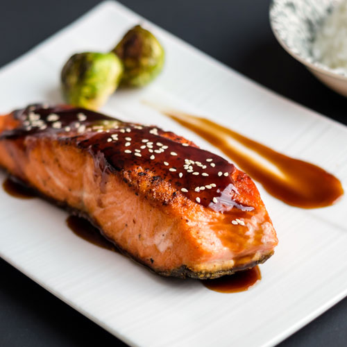 Asian-style salmon on a plate.