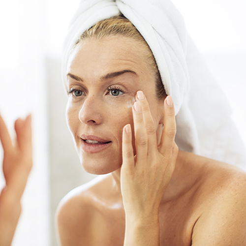 woman looking in mirror