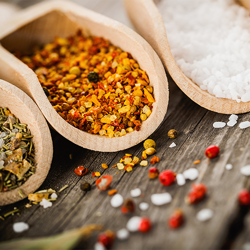 Spices in wooden spoons.