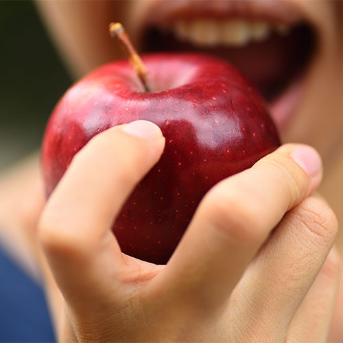 A person eating a apple.